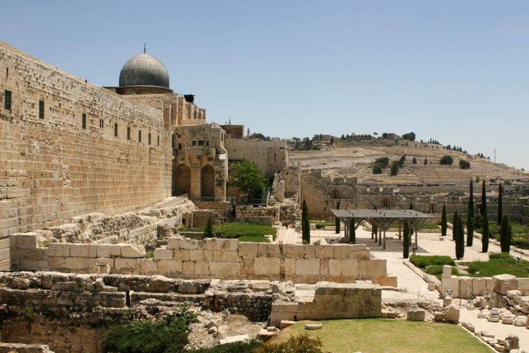 Rebuilt ruins outside the old city wall of Jerusalem, Israel with the Mount of Olives in the background.