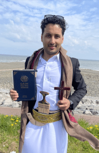 John in traditional Yemeni dress with his "Treasure", the Bible