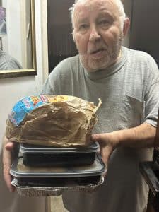 Elderly man in Ashkelon receiving food parcel