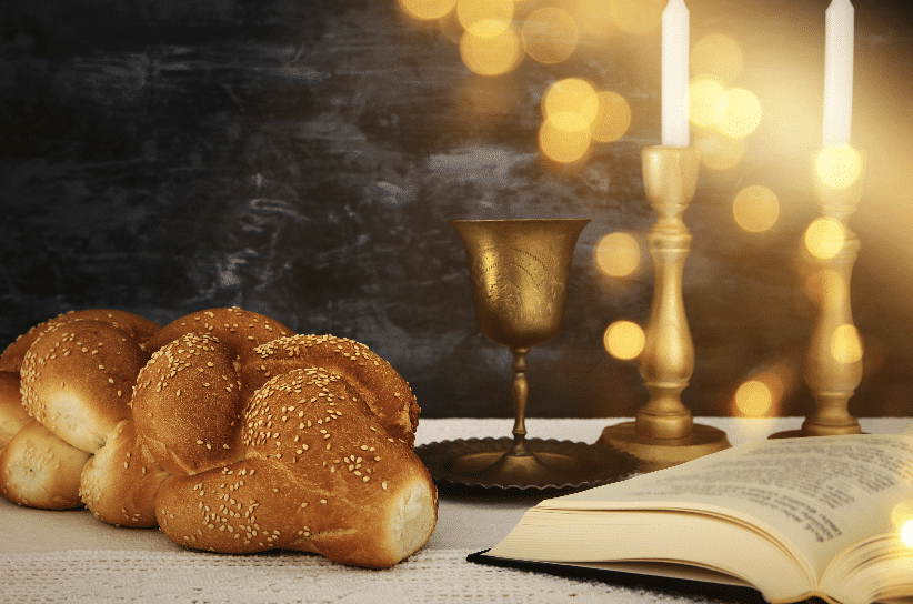 Sabbath challah bread and wine, candles on Shabbat table