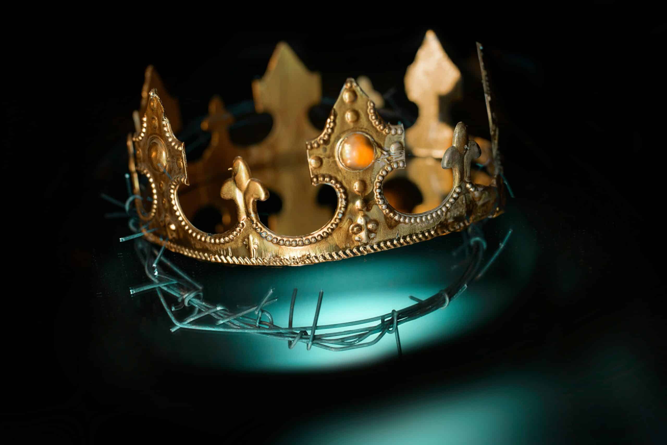 Gold crown resting on twisted barbed wire, set against a dark background, symbolizing power and oppression.